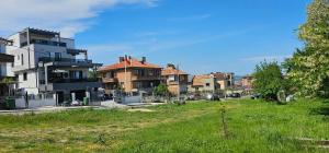 a group of houses in a grassy area with a building at Холидей Обзор-Стая in Obzor +21 photos