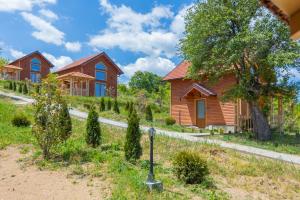a row of houses in a field with trees at Etno selo Čubura - Apartmani in Čubura