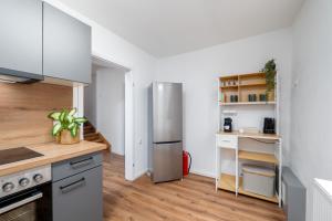 a kitchen with a stainless steel refrigerator and wooden floors at Altstadt-Oase in der Fußgängerzone in Bernkastel-Kues