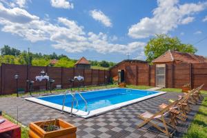 a swimming pool in a yard with a fence at Etno selo Čubura - Apartmani in Čubura
