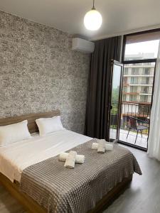 a bedroom with a bed with two towels on it at Leveta Botanical Garden in Batumi