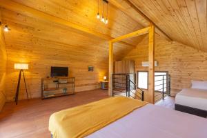 a bedroom with a bed and a tv in a room at Etno selo Čubura - Apartmani in Čubura +54 photos
