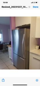 a stainless steel refrigerator in a kitchen at Florida Condo By the Beach in JFK Medical Center Incorporated Heliport