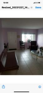 a living room with a couch and a table at Florida Condo By the Beach in JFK Medical Center Incorporated Heliport +3 photos
