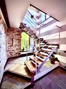 a spiral staircase in a room with a brick wall at La Villetta - cozy house with parking, wifi, wall box and air conditioning in Rapallo +46 photos