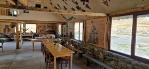 a dining room with a table and a stone wall at Truso Guesthouse in Abano +24 photos