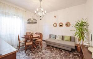 a living room with a table and a couch at Cozy Home In Sori With House Sea View in Sori