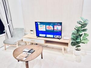 a living room with a tv and a coffee table at vortex luxury apartment klcc in Kuala Lumpur