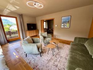 a living room with a couch and chairs and a table at Salzkammergut Hideaway RUDOLPH in Bad Ischl
