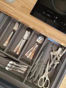a drawer filled with silver utensils in a kitchen at Long Meadow Shepherd Hut - Brecon Beacons, LD3 7TD in Tal-y-llyn +48 photos