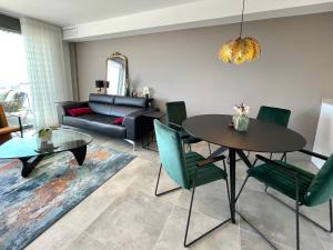 a living room with a table and a couch at Seascape Luxury Finestrat in Finestrat