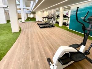 a gym with treadmills and exercise bikes in a room at Seascape Luxury Finestrat in Finestrat