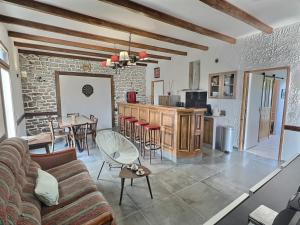 a living room with a couch and a table and a kitchen at Villa ocean in Loctudy