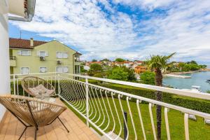 a balcony with a chair and a view of the water at Villa Gisela in Malinska