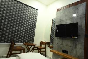 TV a/nebo společenská místnost v ubytování Hotel Tim Hartins