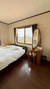 A bed or beds in a room at Kitayama Fuji View House