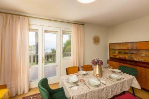 a dining room with a table and a window at Villa Gisela in Malinska