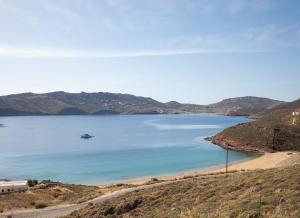 a view of a beach with a boat in the water at Villa Sozon Mykonos in Agios Sostis Mykonos