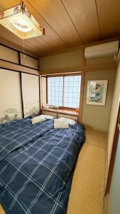 A bed or beds in a room at Kitayama Fuji View House