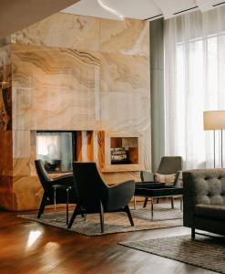 a living room with a table and chairs and a fireplace at Le Meridien Arlington in Arlington