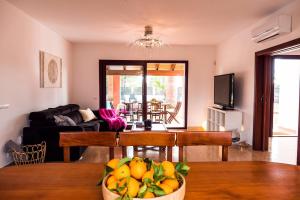a living room with a bowl of fruit on a table at Villa Menorca cerca del mar Alcudia in Alcudia
