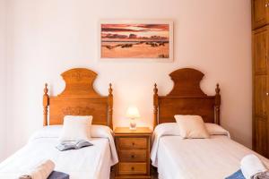 a bedroom with two beds and a picture on the wall at Villa Menorca cerca del mar Alcudia in Alcudia +28 photos