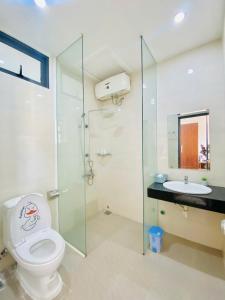 a bathroom with a toilet and a sink at Pina Home in Da Nang