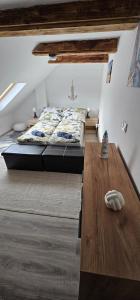 a bedroom with a bed and a wooden table at Balatomi Apartman in Balatonföldvár