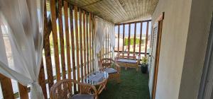 a screened in porch with two chairs and a table at Balatomi Apartman in Balatonföldvár
