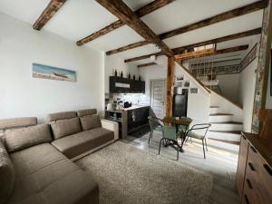 a living room with a couch and a table at Balatomi Apartman in Balatonföldvár