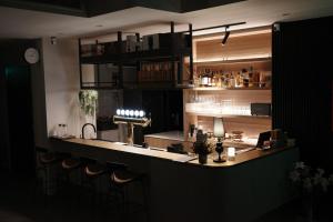 a bar with a row of stools in a restaurant at Brewstay in Luye