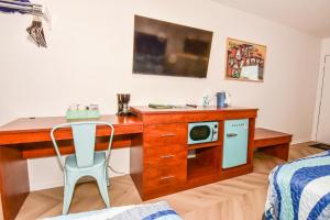 a room with a desk with a microwave at The Lake House Inn in Laurie