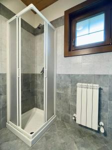 a shower with a glass door in a bathroom at Casa Viva B&B in Trivero