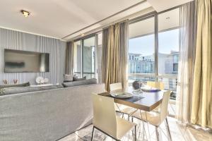 a living room with a couch and a table at Harbour Bridge Apartment on Waterfront Canal in Cape Town