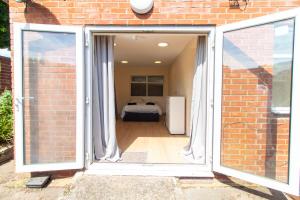 an open door leading to a bedroom with a bed at Brookvale Guest House Room 8 in Southampton