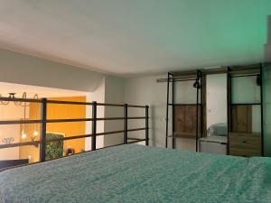 a bedroom with a bed and glass doors and a bed at Dúplex tipo loft de estilo selvático y safari, con encanto y a pasos del mar in Valencia