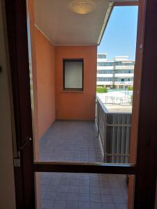 a hallway with a door leading to a balcony at SummerJoy in Bibione