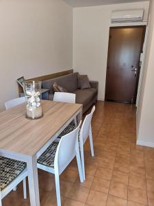 a living room with a table and a couch at SummerJoy in Bibione