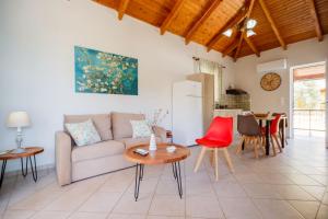 a living room with a couch and a table at Porto Gerakas Villas in Vasilikos