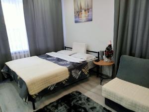 a bedroom with a bed and a chair in it at Family Home in Petropavlovsk