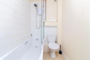 a white bathroom with a toilet and a shower at Brookvale Guest House Room 9 in Southampton