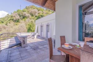 a room with a balcony with a table at Beautiful Dream in Perledo