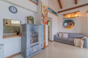 a living room with a fireplace and a couch at Beautiful Dream in Perledo