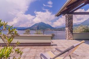 a patio with a chair and a view of the mountains at Beautiful Dream in Perledo