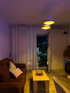 a living room with a couch and a coffee table at Down town Apartment in Gnjilane