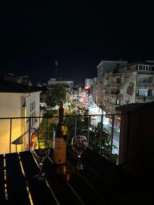 a bottle of wine sitting on a table with wine glasses at Down town Apartment in Gnjilane +26 photos