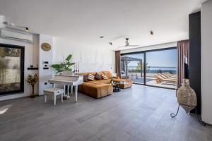 a living room with a couch and a piano at Seaside Villa Leonis - Gym, Sauna and a pool in Podstrana
