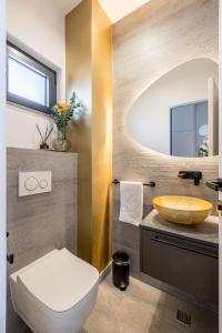 a bathroom with a toilet and a sink at Seaside Villa Leonis - Gym, Sauna and a pool in Podstrana