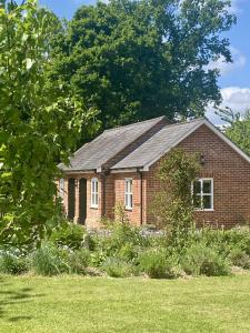 a brick house with a gambrel roof at The Old Coach House in Bungay
