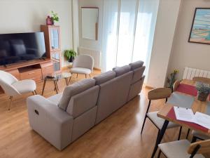 a living room with a couch and a television at La casa de siempre in Alba de Tormes